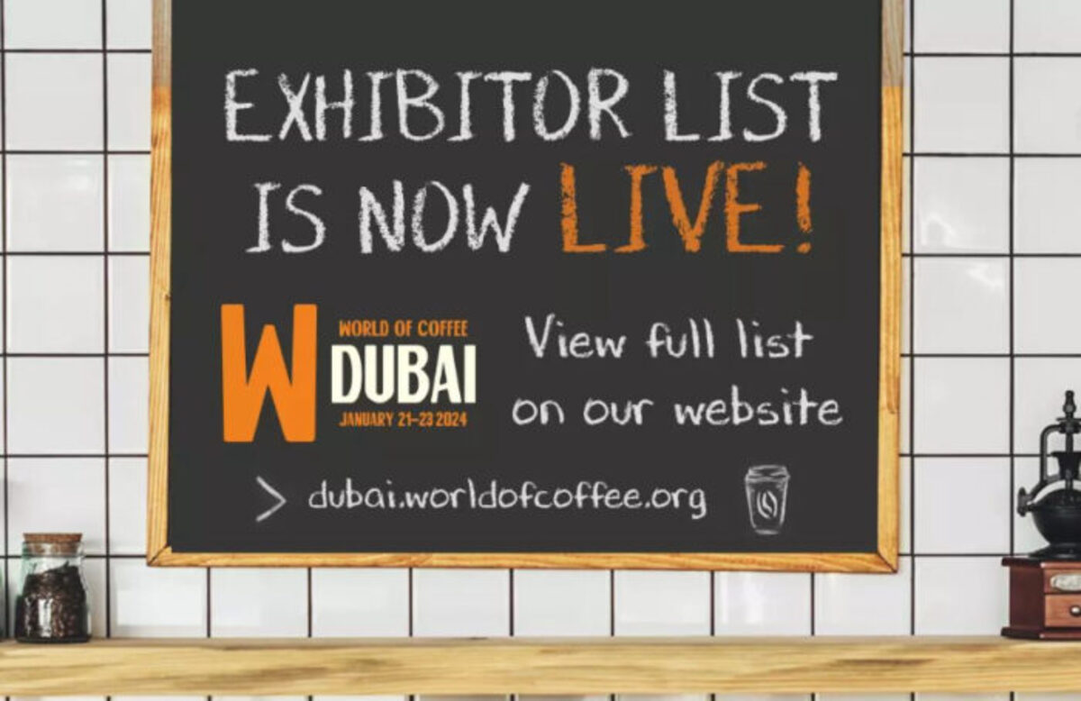 A chalkboard sign announces that the exhibitor list for World of Coffee Dubai 2024 is now live, with event details and website link.