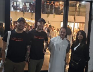Antonio Orria stands with team members and guests outside the Simonelli Group Experience Lab in Dubai, celebrating his new role in the Middle East.