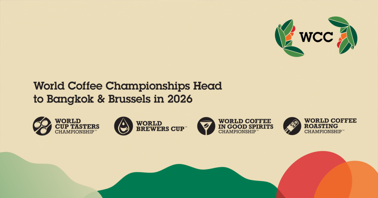 Promotional banner for the 2026 World Coffee Championships. The text reads “World Coffee Championships Head to Bangkok & Brussels in 2026,” with logos for four competitions: World Cup Tasters Championship, World Brewers Cup, World Coffee in Good Spirits Championship, and World Coffee Roasting Championship. The WCC logo appears at the top right, with colorful abstract shapes along the bottom.
