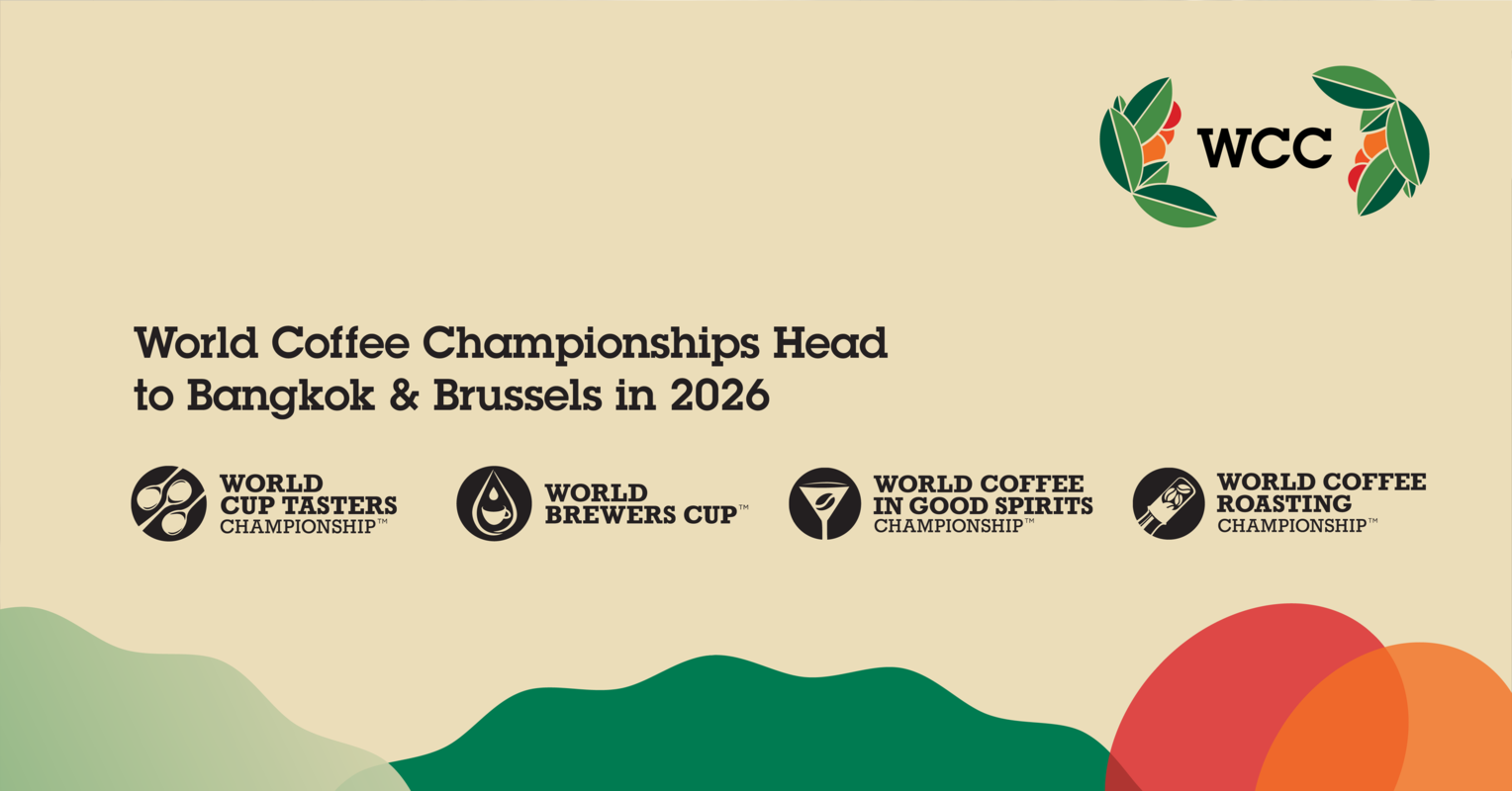 Promotional banner for the 2026 World Coffee Championships. The text reads “World Coffee Championships Head to Bangkok & Brussels in 2026,” with logos for four competitions: World Cup Tasters Championship, World Brewers Cup, World Coffee in Good Spirits Championship, and World Coffee Roasting Championship. The WCC logo appears at the top right, with colorful abstract shapes along the bottom.