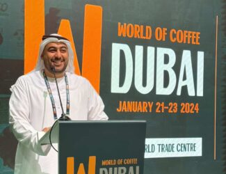 Saeed Rashid Al Baloushi speaking at the World of Coffee Dubai 2024 event at Dubai World Trade Centre.