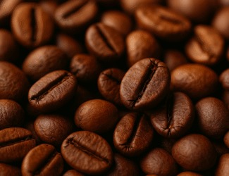 Close-up of roasted coffee beans with rich brown tones, showing detailed textures, cracks, and natural sheen, captured in warm soft lighting.