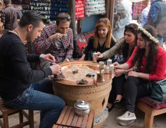 Traditional Turkish coffee served in a cezve with lokum and water, symbolizing hospitality and cultural heritage in Turkey.