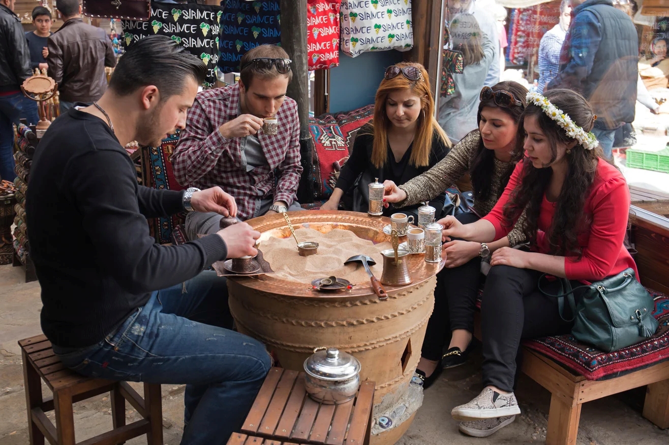 Traditional Turkish coffee served in a cezve with lokum and water, symbolizing hospitality and cultural heritage in Turkey.