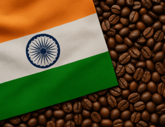 The Indian national flag placed over a surface of roasted coffee beans, symbolizing India’s coffee industry and its connection to national identity.
