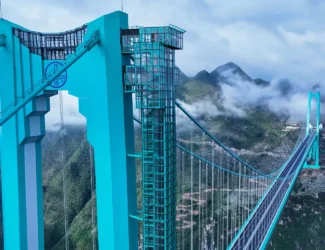 Aerial view of the Huajiang Grand Canyon Bridge in China’s Guizhou province with the glass café Interstellar Coffee on top.