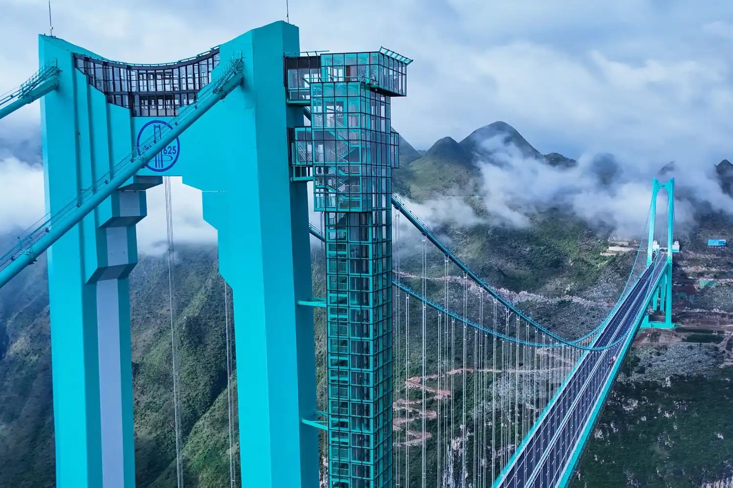 Aerial view of the Huajiang Grand Canyon Bridge in China’s Guizhou province with the glass café Interstellar Coffee on top.